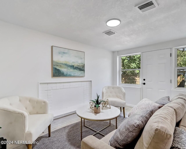 living room featuring a brick fireplace