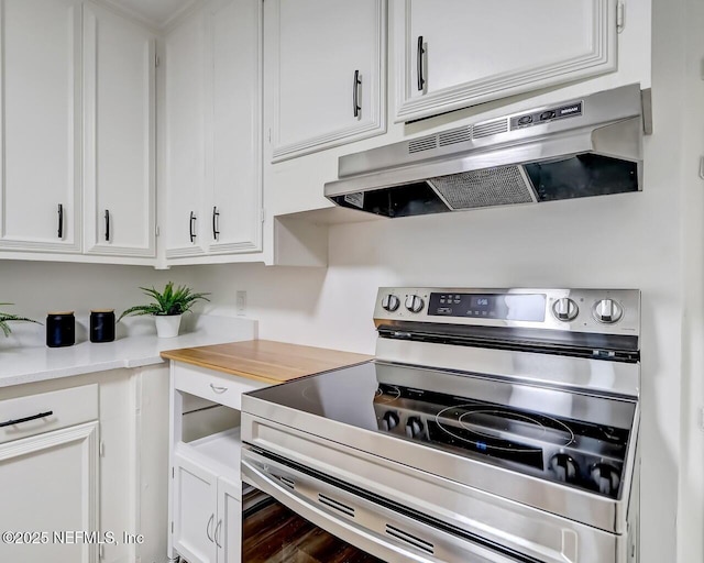 kitchen featuring white cabinetry and stainless steel electric range