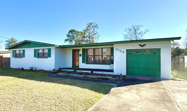 ranch-style home with a garage and a front lawn