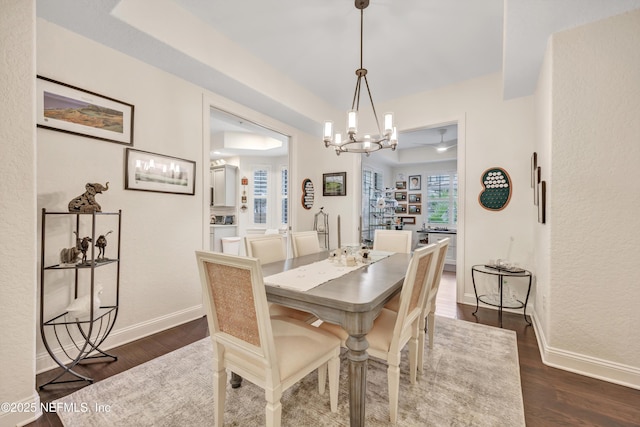 dining space with an inviting chandelier and dark hardwood / wood-style floors