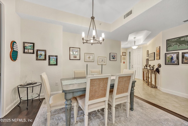 tiled dining area featuring a chandelier