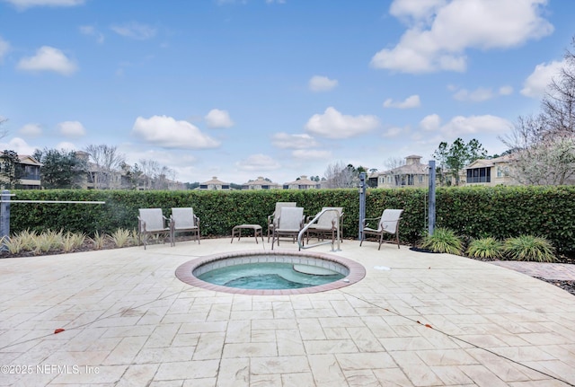 view of swimming pool featuring a patio and an in ground hot tub