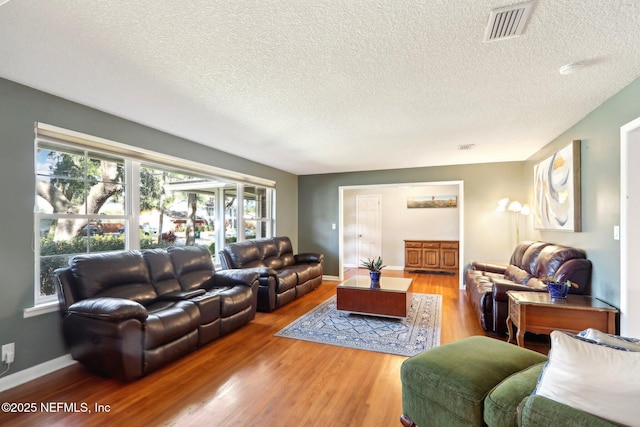 living room with hardwood / wood-style flooring and a textured ceiling