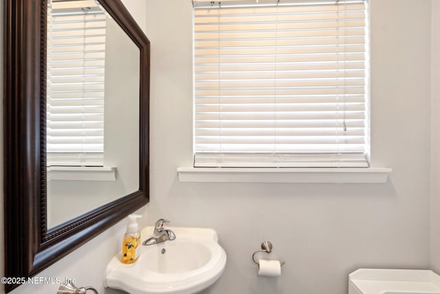 bathroom featuring toilet and a sink