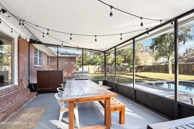 unfurnished sunroom with rail lighting