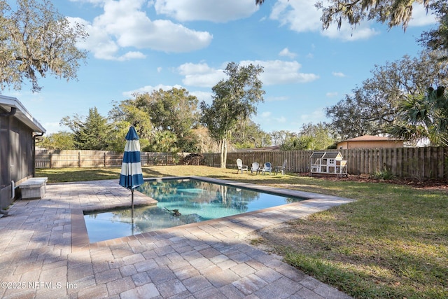 view of swimming pool featuring a fenced in pool, a patio area, a lawn, and a fenced backyard