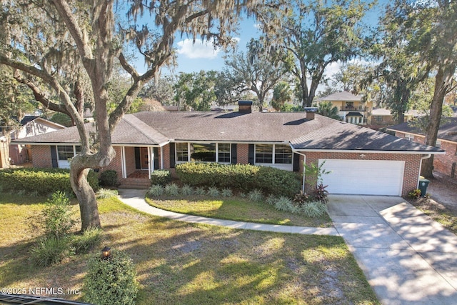 ranch-style home featuring a garage and a front lawn