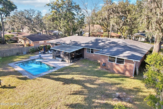 view of swimming pool with a yard, a patio, a fenced in pool, and a fenced backyard