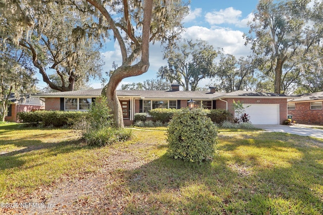 ranch-style house featuring driveway, a front yard, brick siding, and an attached garage