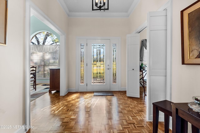 doorway to outside featuring crown molding and light parquet floors