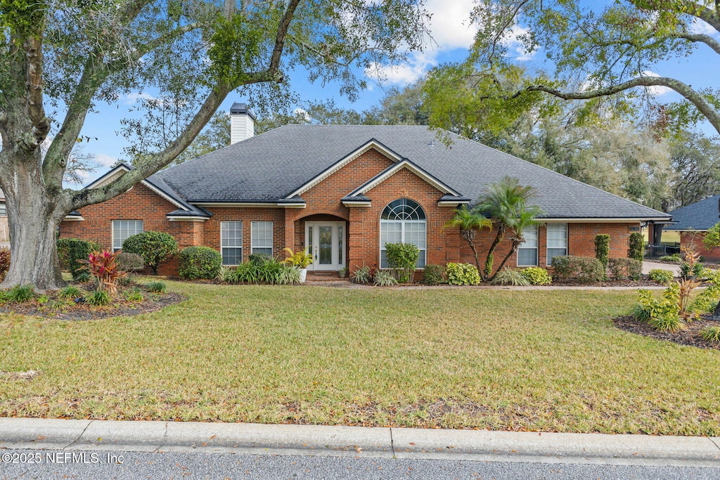 ranch-style house featuring a front yard