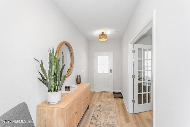 doorway to outside with light wood-type flooring