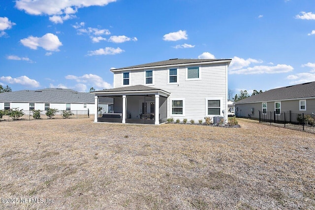 rear view of house with a patio area and a sunroom