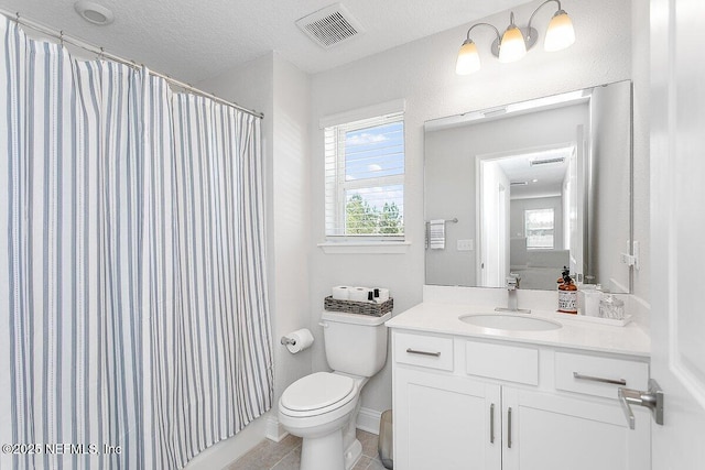 bathroom featuring toilet, a shower with curtain, a textured ceiling, vanity, and tile patterned flooring