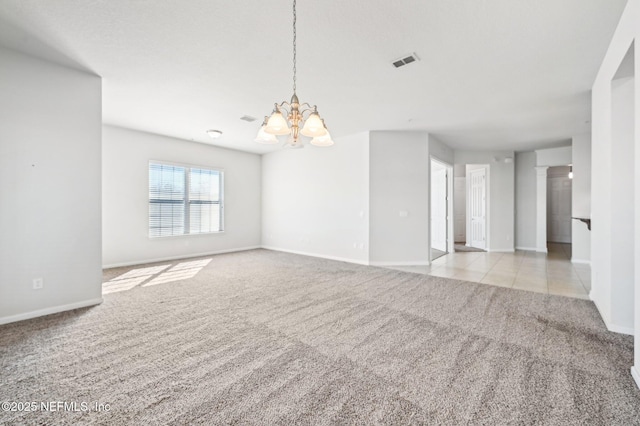 unfurnished living room featuring light carpet and an inviting chandelier