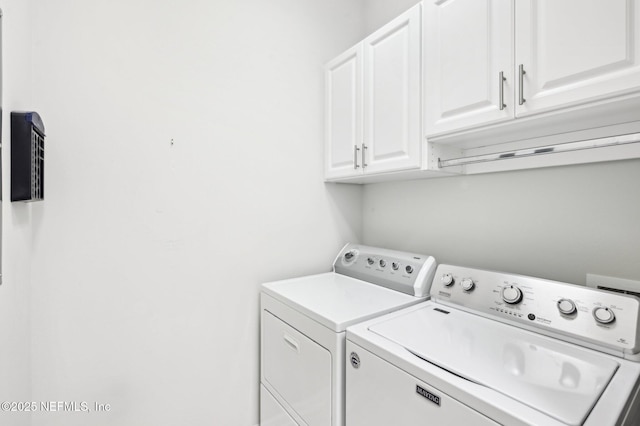 laundry room with independent washer and dryer and cabinets