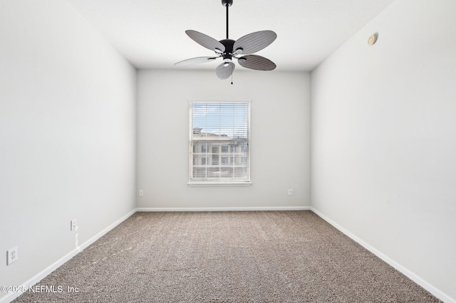 carpeted spare room featuring ceiling fan