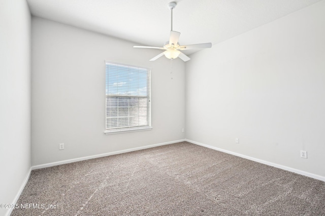 unfurnished room with ceiling fan and carpet flooring