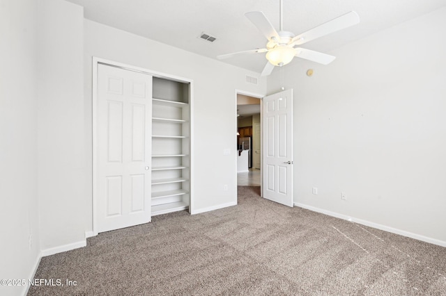 unfurnished bedroom featuring ceiling fan, a closet, and carpet