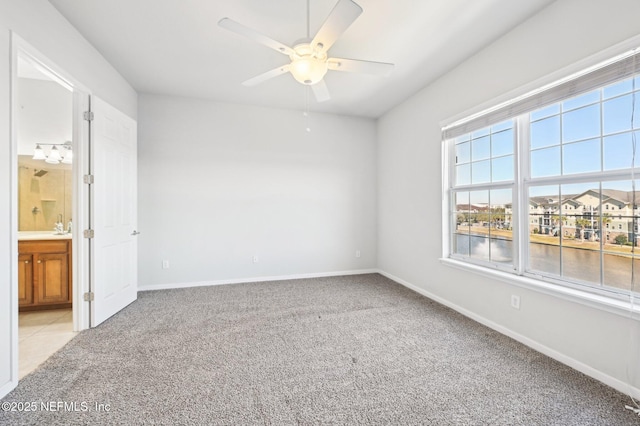 carpeted empty room featuring ceiling fan