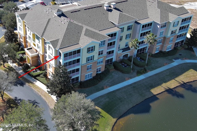 birds eye view of property with a water view