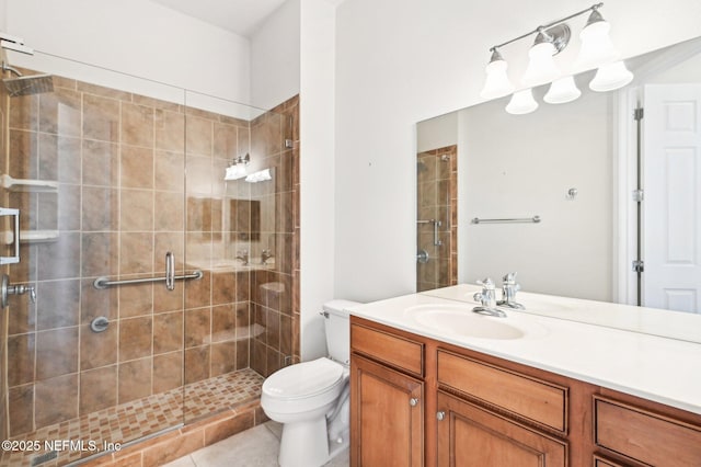 bathroom with an enclosed shower, vanity, tile patterned floors, and toilet