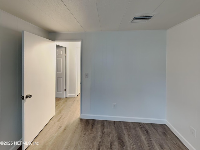 unfurnished room with hardwood / wood-style floors