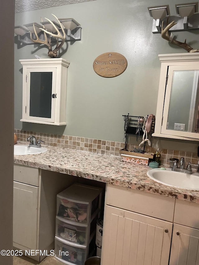 bathroom featuring vanity and decorative backsplash