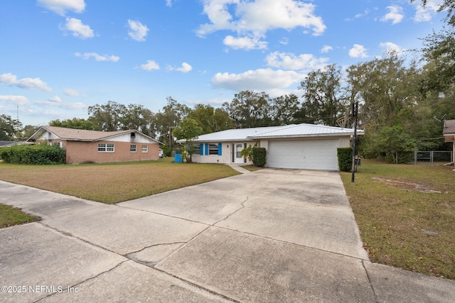 ranch-style home with a garage and a front lawn