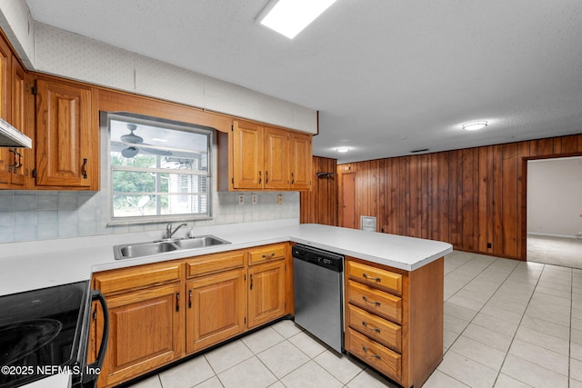 kitchen featuring sink, light tile patterned floors, stainless steel dishwasher, kitchen peninsula, and range with electric cooktop