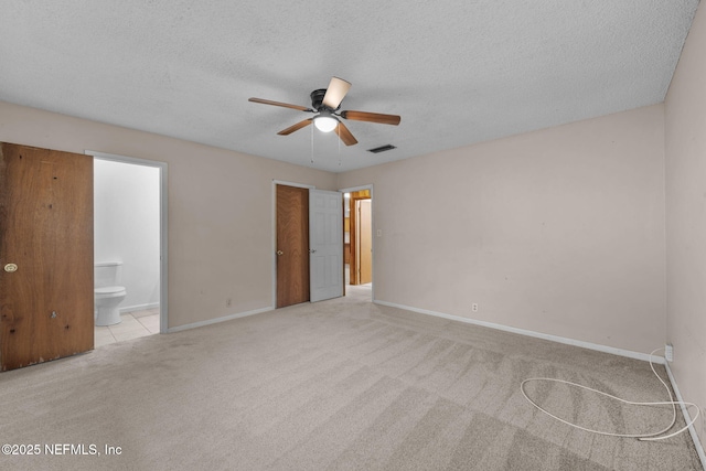 carpeted spare room with ceiling fan and a textured ceiling