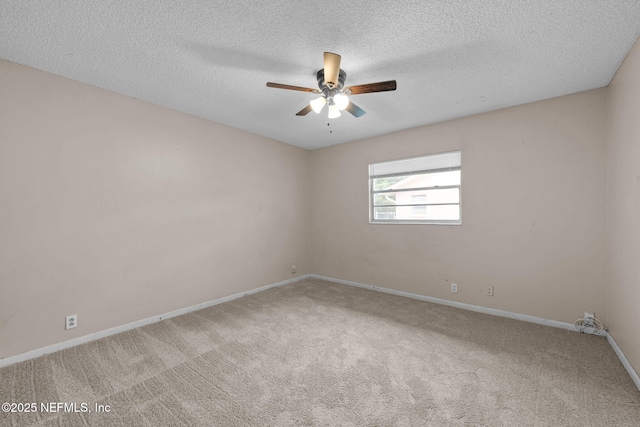 carpeted spare room featuring ceiling fan and a textured ceiling