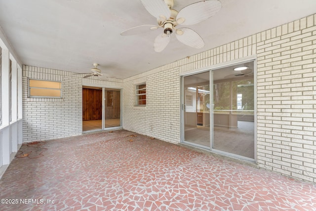 unfurnished sunroom featuring ceiling fan