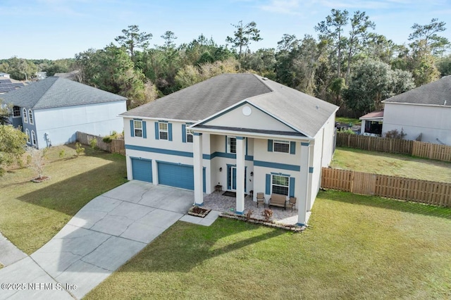 view of front of house with a garage and a front lawn