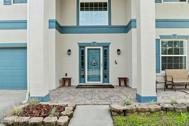 doorway to property with a garage