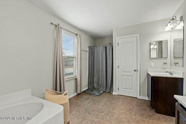 bathroom featuring vanity, tile patterned flooring, and a bathtub