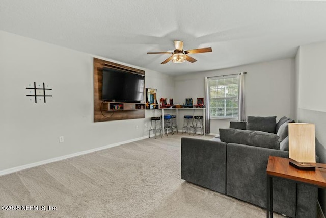 carpeted living room with ceiling fan