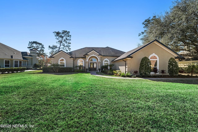 ranch-style house featuring a front lawn