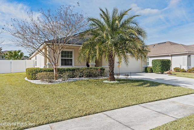 view of front facade with a garage and a front lawn