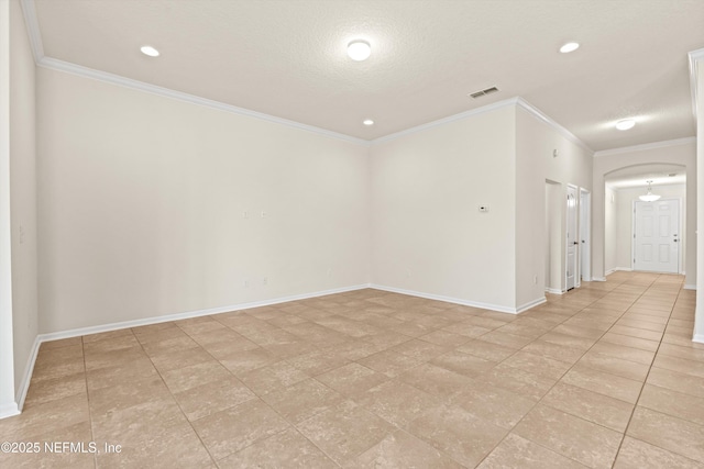 empty room featuring crown molding and a textured ceiling