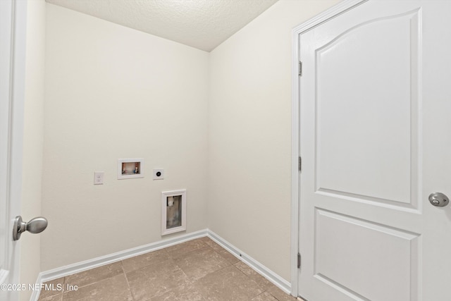 laundry area featuring hookup for a washing machine, electric dryer hookup, and a textured ceiling