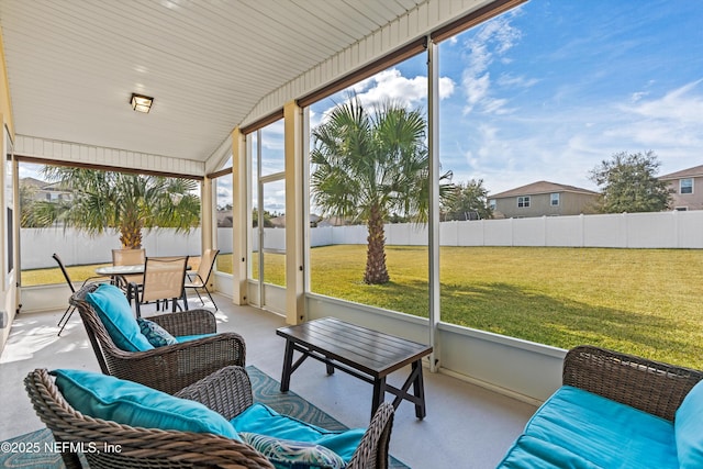 sunroom featuring a healthy amount of sunlight and vaulted ceiling