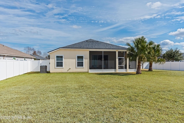 back of property featuring central AC, a sunroom, and a lawn