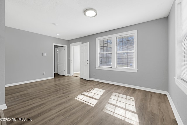 spare room with dark wood-type flooring