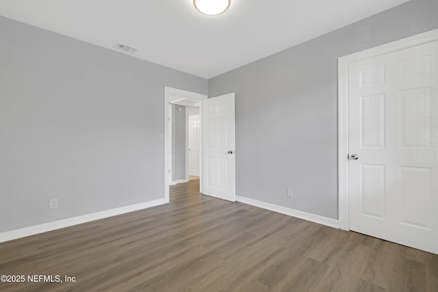 unfurnished bedroom with wood-type flooring