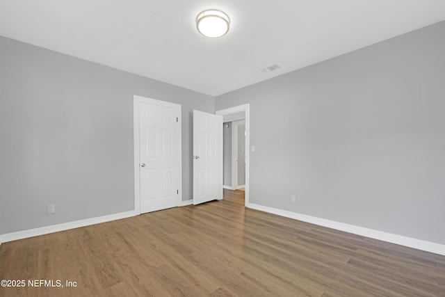 unfurnished bedroom featuring hardwood / wood-style flooring