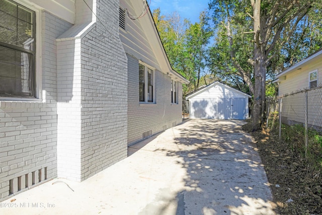 view of side of property featuring a garage and an outbuilding