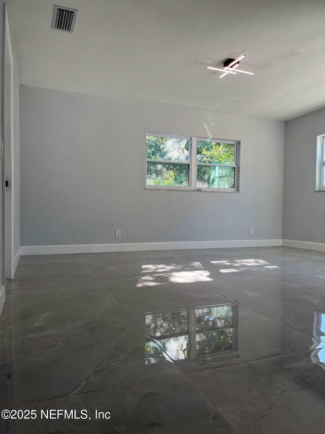 spare room with a textured ceiling