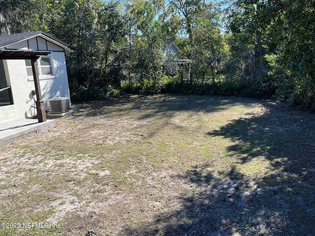 view of yard featuring central air condition unit