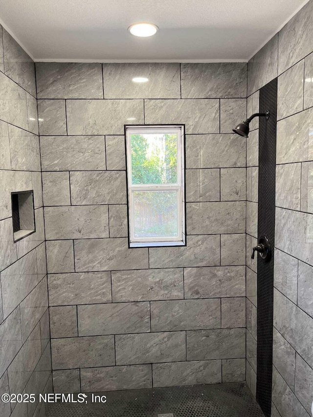 bathroom with a tile shower